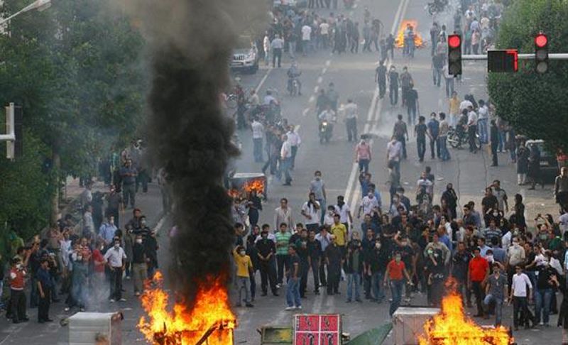 Protestors gather during a march on a street in Tehran