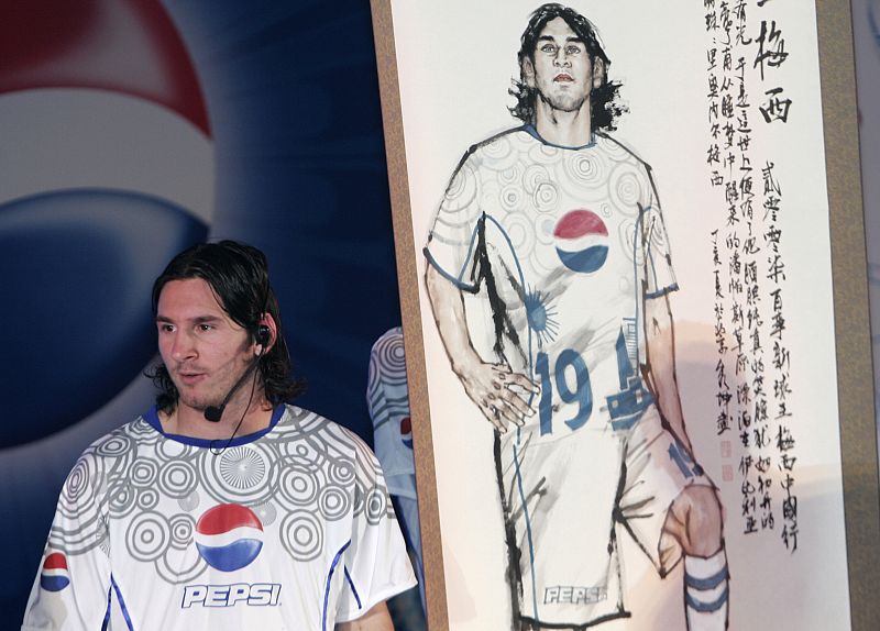 Argentina's soccer player Lionel Messi stands next to a Chinese traditional painting of himself during a promotion event in Beijing