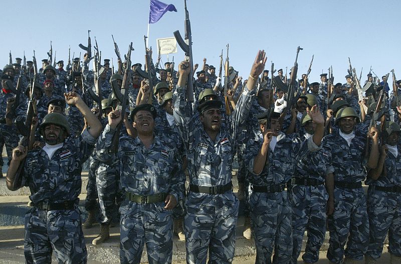 Iraqi policemen celebrate as they mark the U.S. withdrawal from Iraqi cities, in Ramadi