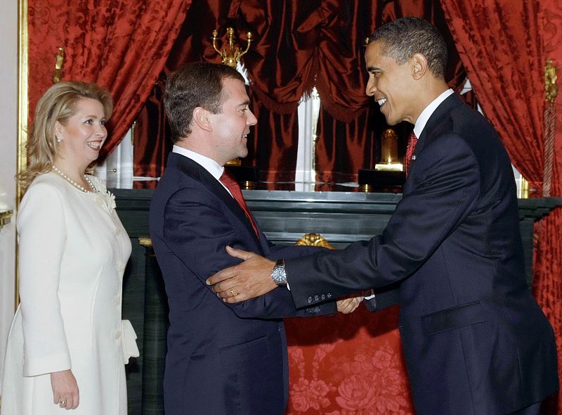 U.S. President Barack Obama and Russia's President Dmitry Medvedev meet as first lady Svetlana Medvedev looks on at the Kremlin in Moscow