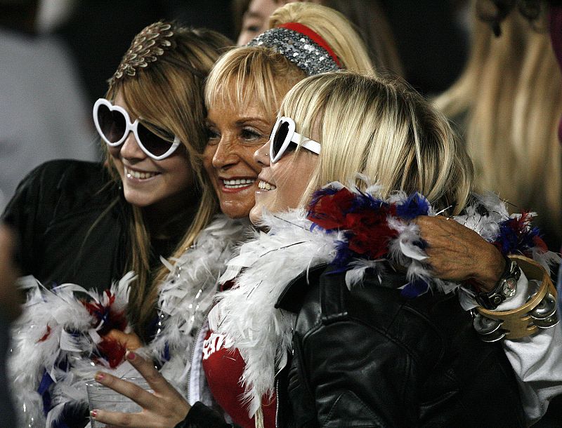 Fans pose for photograph before Madonna's Sticky and Sweet tour performance at Dodgers stadium in Los Angeles