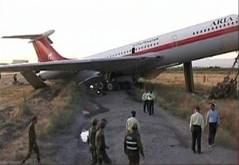 Video grab of officials looking at the wreckage of a passenger airplane in Mashhad