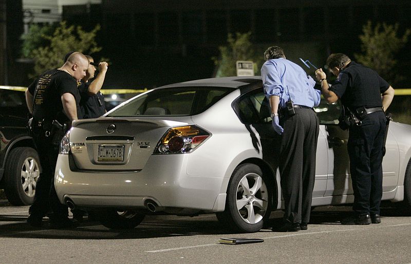 Police examine a car in the parking lot outside the LA Fitness gym in Bridgeville