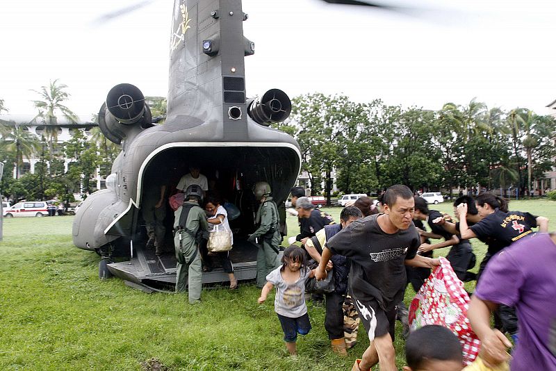 Handout from Taiwan Military News Agency shows people running out of army CH-47 Chinook transport helicopter after being evacuated from flooded village of Namaxia