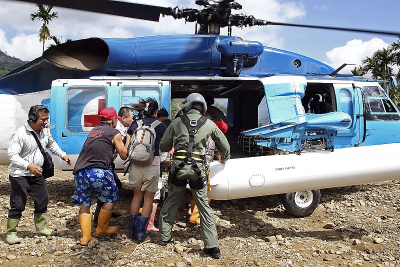 A handout photograph from the Taiwan Military News Agency shows soldiers helping survivors evacuate the flooded village of Laiji