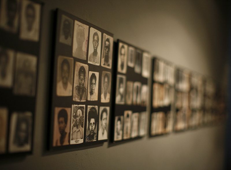 Photographs of Rwandan genocide victims are shown on a gallery wall during a visit by U.S. President Bush and first lady Laura in Kigali