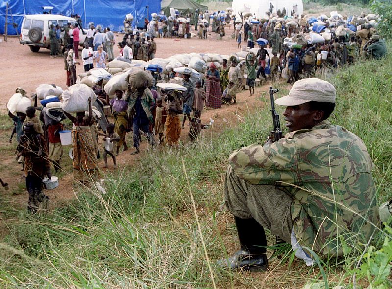 A government soldier guards a Hutu refugee camp in this village in southern Rwanda April 26. The ref..