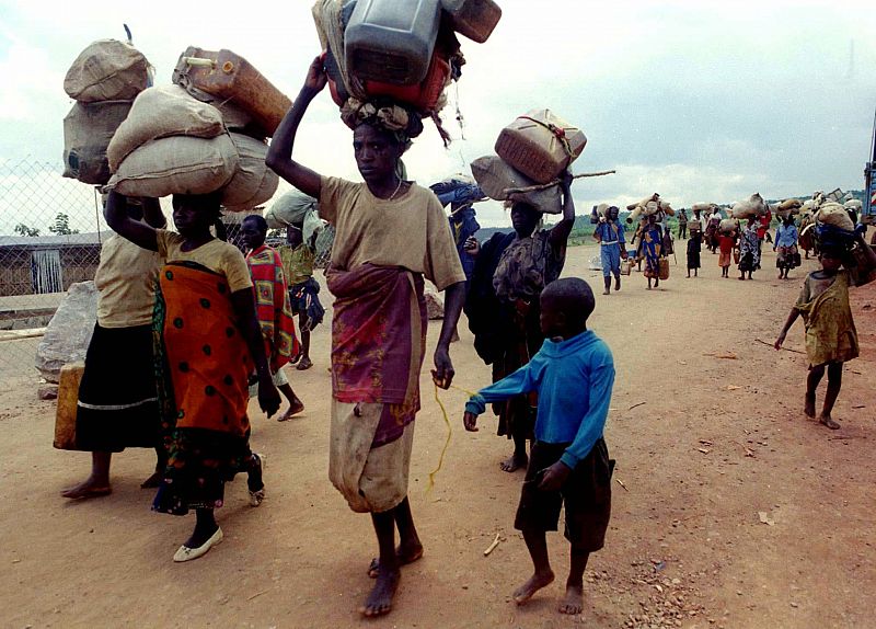 Rwandan refugees walk from their camp of Benaco in Tanzania towards the Rwandan border on their way ..