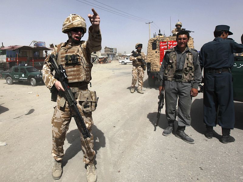 A British soldier and Afghan policeman secure the area of a suicide attack in Kabul