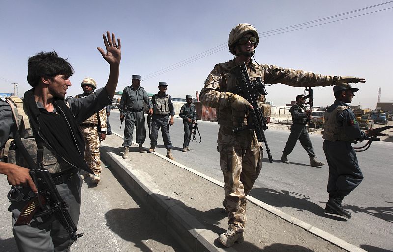 A British soldier and Afghan policeman secure the area of a suicide attack in Kabul