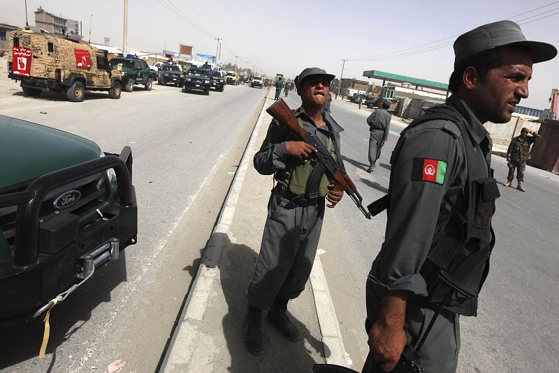 Afghan policeman secure the area of a suicide attack in Kabul