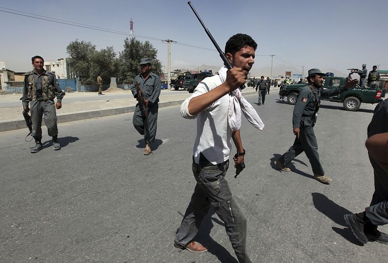 Afghan policemen secure the area of a suicide attack in Kabul