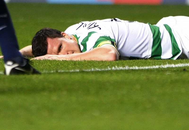 Celtic's Caldwell lies face down on the pitch after he let in an own goal during their Champions League qualifying soccer match against Arsenal in Glasgow, Scotland