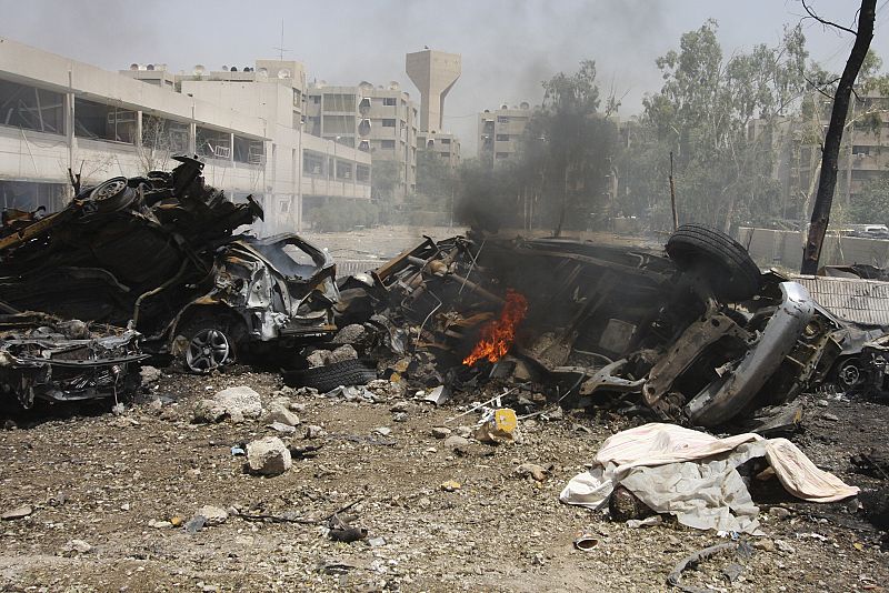 Burned and destroyed vehicles are seen at the site of a bomb attack in Baghdad