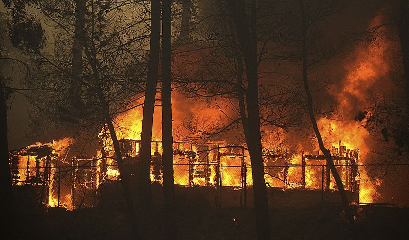 An unknown structure burns during the Station Fire in the Big Tujunga Canyon area of Los Angeles