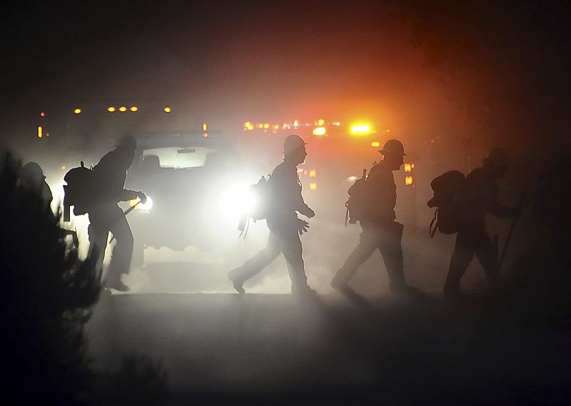 Los bomberos tratan de iluminar la zona para trabajar en las horas nocturnas contra el fuego.