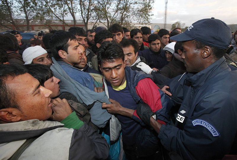 Police evacuate illegal migrants from an improvised camp in Calais