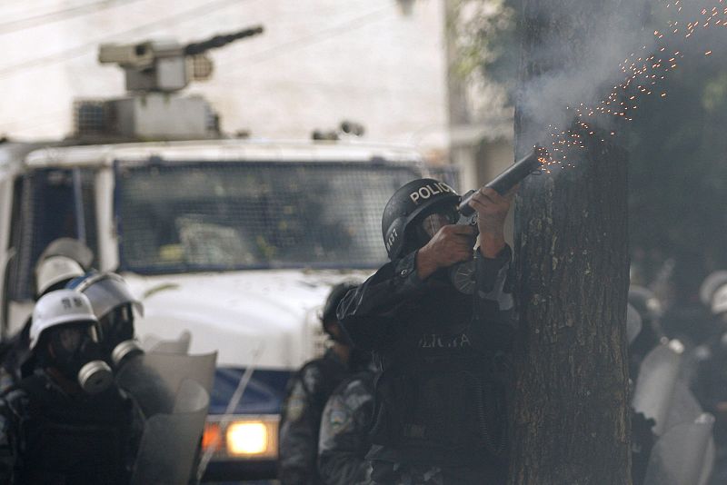 A policeman fires a canister of tear gas at supporters of ousted Honduras President Manuel Zelaya, near the Brazilian embassy in Tegucigalpa