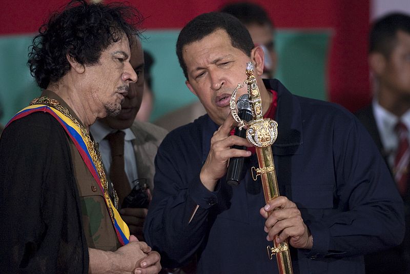Venezuela's President Hugo Chavez presents Libya's leader Muammar Gaddafi with a replica of the sword of national hero Simon Bolivar, in Margarita Island