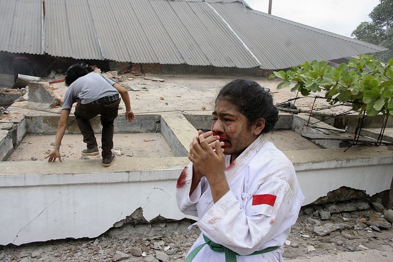 An injured girl cries during an evacuation after an earthquake hit Padang, Indonesia's Sumatra island