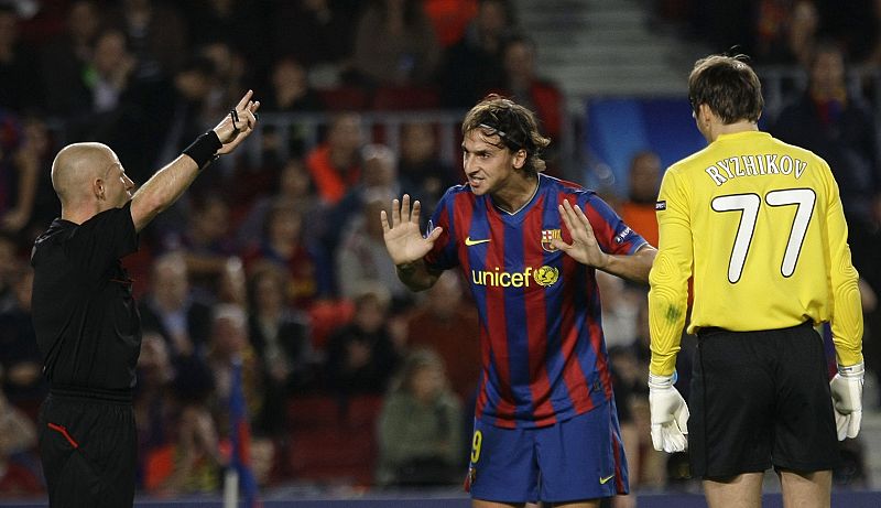 Barcelona's Zlatan Ibrahimovic argues with the referee in front of Rubin Kazan's goalkeeper Sergei Ryzhikov during their Champions League soccer match at the Camp Nou stadium in Barcelona