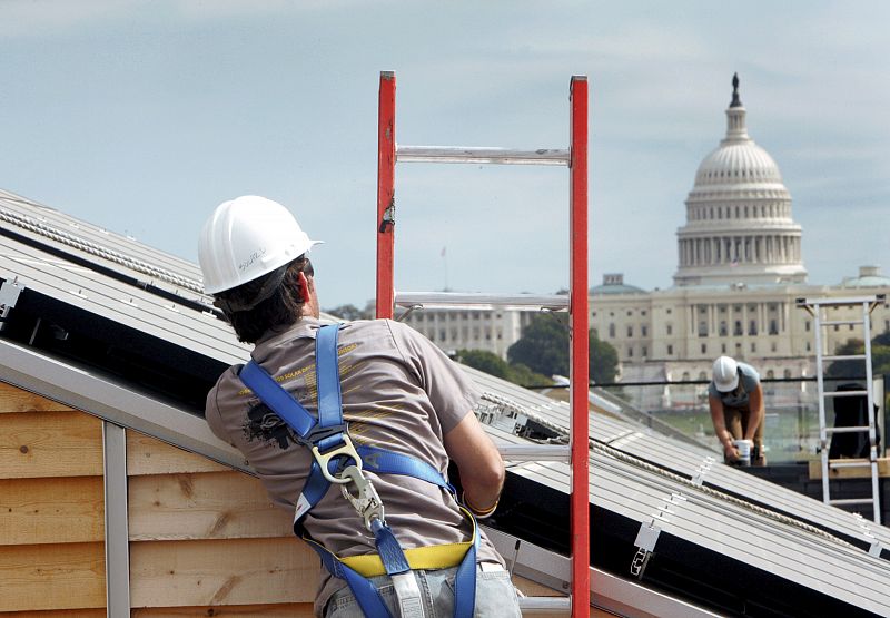 Students work on the roof of their houses during the 2009 U.S. Department of Energy Solar Decathlon on the National Mall in Washington