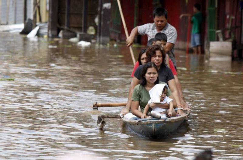 Filipinos son evacuados en canoas tras las fuertes inundaciones en la población de Santa Cruz, en la provincia de Laguna, al sur de Manila (Filipinas).