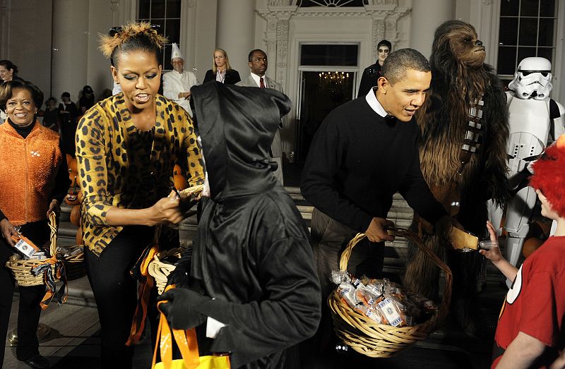 The Obama family greets local school children on Halloween at the White House in Washington