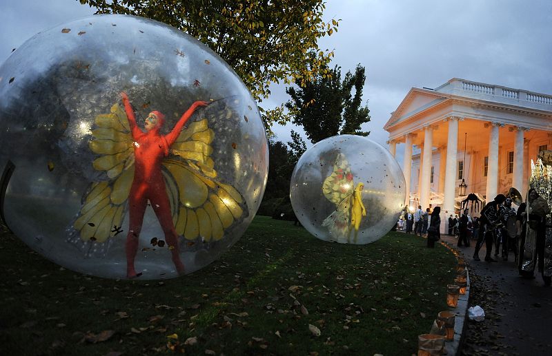 Performers greet local school children as they arrive for a Halloween reception at the White House in Washington