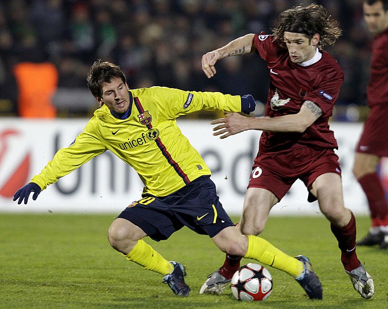 Barcelona's Messi challenges Rubin Kazan's Sharonov during their Champions League soccer match at the Central stadium in Kazan