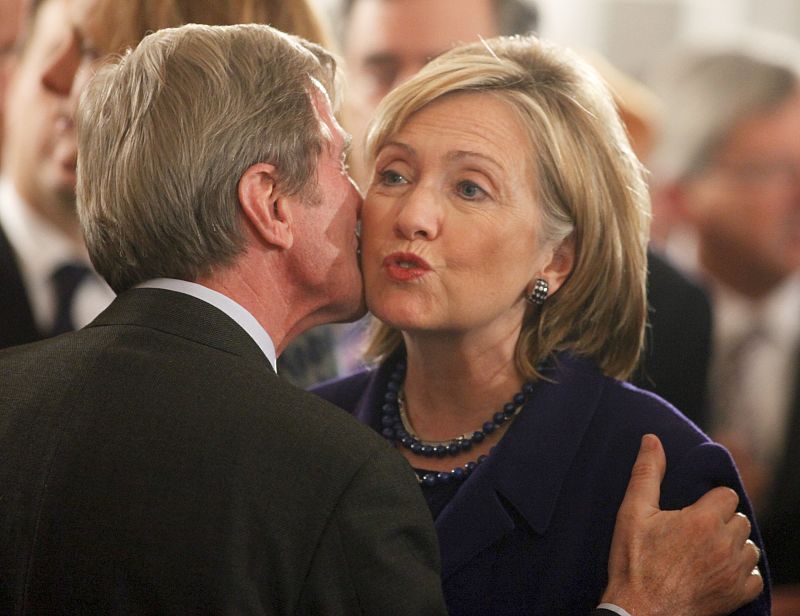 French Foreign Minister Kouchner kisses U.S. Secretary of State Clinton during a reception at the presidential Bellevue Palace in Berlin
