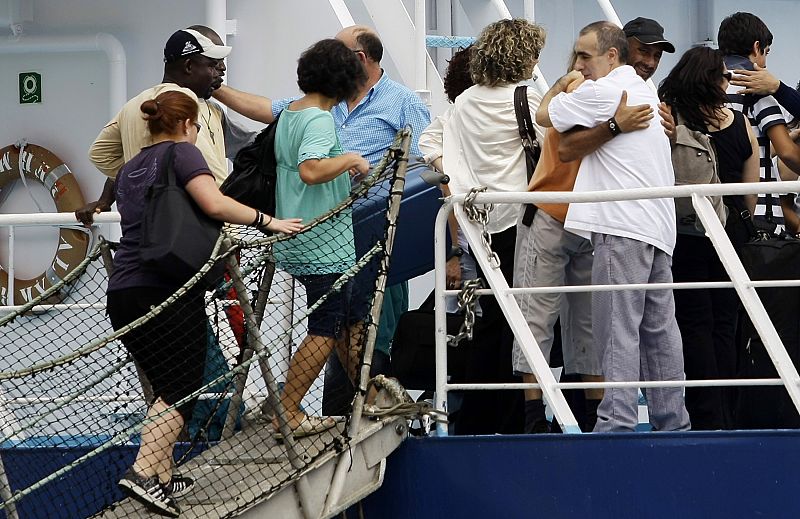 The crew members of the Spanish tuna fishing boat Alakrana welcome relatives and friends onboard after arriving at port Victoria on the Seychelles island of Mahe