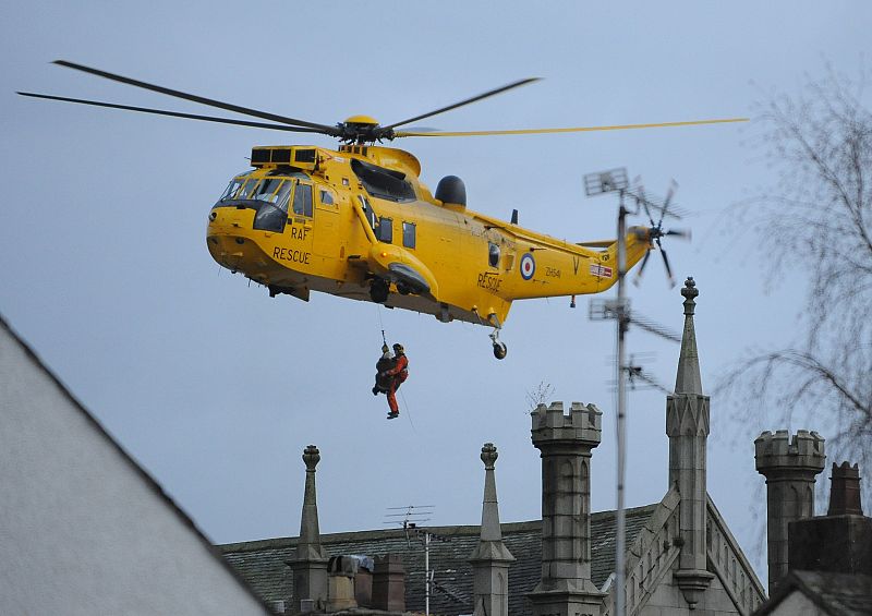 People are lifted into a helicopter to avoid flood waters in Cockermouth