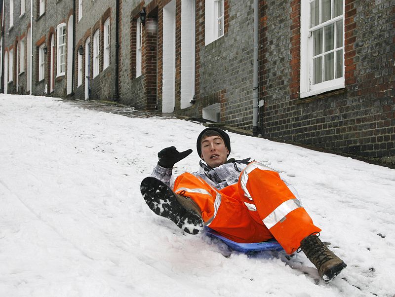 A man loses control of his sledge in the snow on a street in Lewes, southeast England