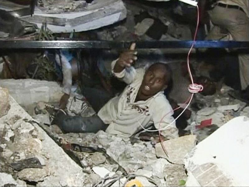 A man calls for help while being trapped at the Port-au-Prince University, after a major earthquake struck, in Port-au-Prince