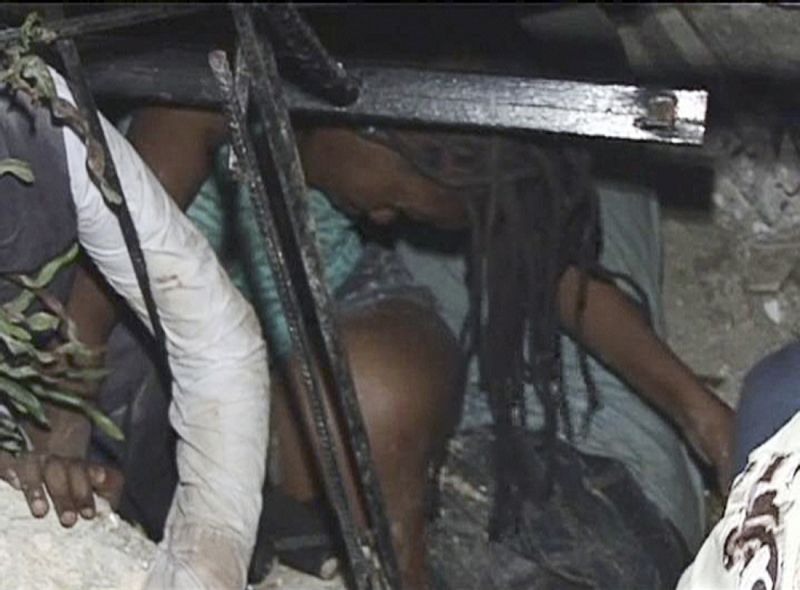 A woman is trapped at the Port-au-Prince University, after a major earthquake struck, in Port-au-Prince