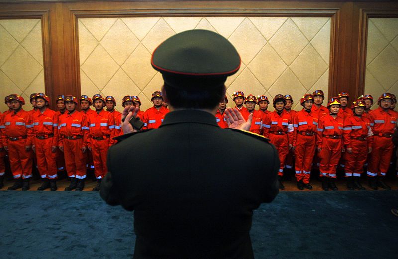 A senior military officer speaks to members of China International Search and Rescue Team during a departure ceremony at Beijing airport