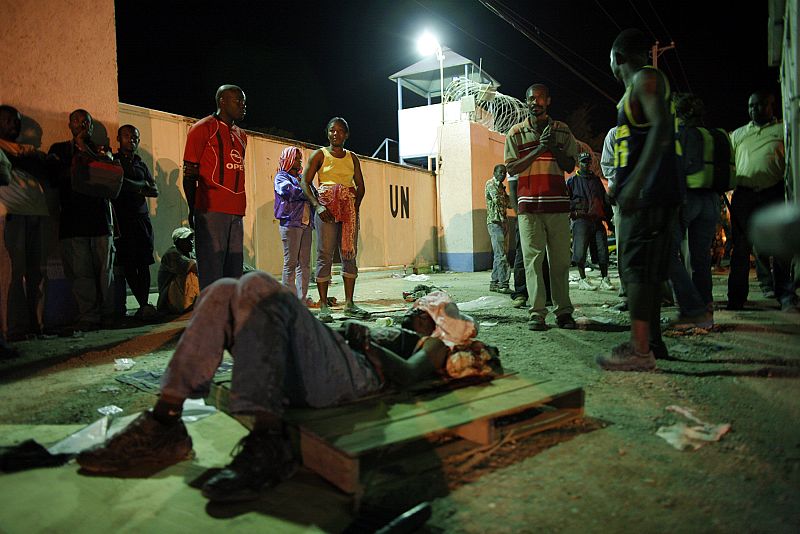A injured resident waits for medical attention after an earthquake in Port-au-Prince