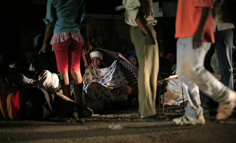 Residents rest on the street after an earthquake in Port-au-Prince