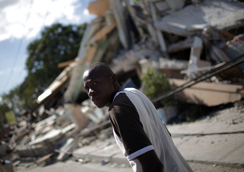 A man walks next to a destroyed building after major earthquake hit Port-au-Prince,