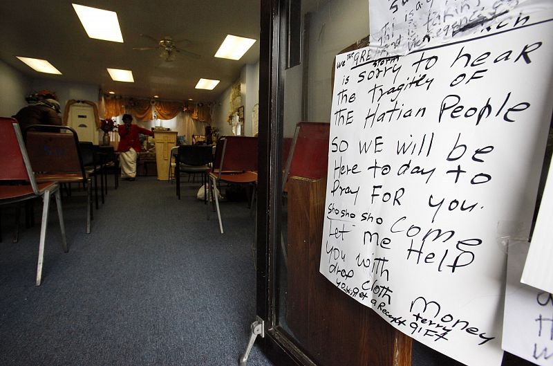 A sign announcing that the church will be open for people to pray for the victims of Haiti's earthquake is seen in Brooklyn