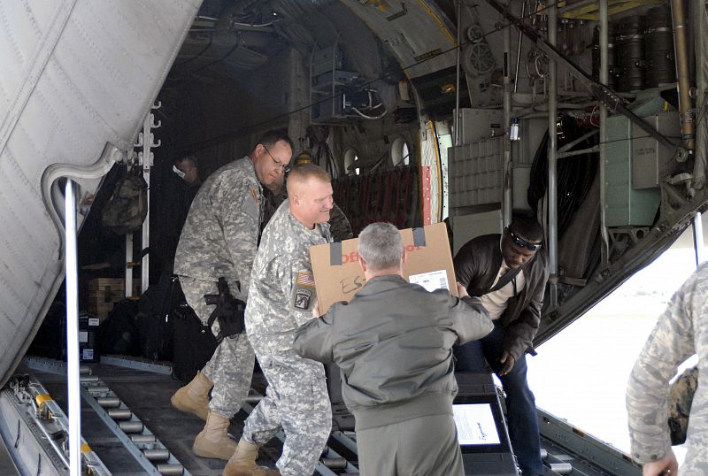 A U.S. Southern Command assessment team boards a C-130 Hercules aircraft in Miami