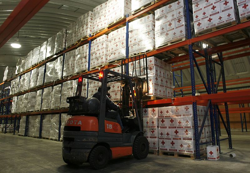 A Red Cross worker unloads humanitarian aid boxes to be sent to Haiti at the Red Cross Center in Toluca