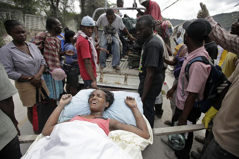 An injured person is evacuated after a major earthquake hit the Haitian capital Port-au-Prince