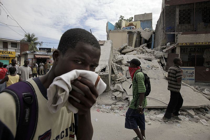 Residents walk in a destroyed area after a major earthquake hit the Haitian capital Port-au-Prince