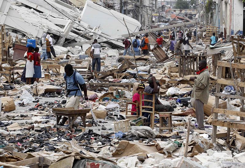 Residents walk in a destroyed area after a major earthquake hit the Haitian capital Port-au-Prince