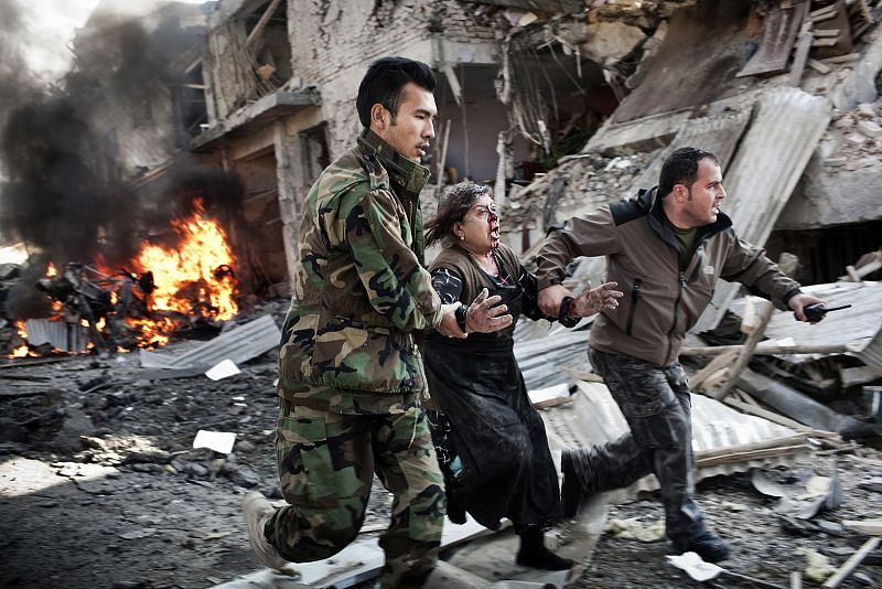 Adam Ferguson, a photographer for VII Mentor Program for The New York Times based in Australia, won the first prize in the Spot News Singles category for this picture of an Afghan woman being rushed from the scene of a suicide bombing, Kabul