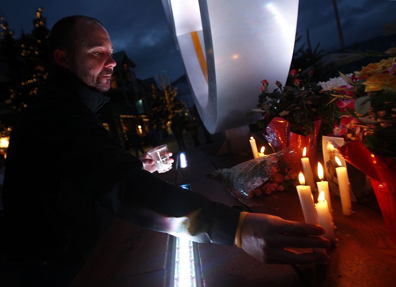 A man places a candle in commemoration of late Nodar Kumaritashvili of Georgia at the Whistler medal plaza ahead of the Vancouver 2010 Winter Olympics in Whistler