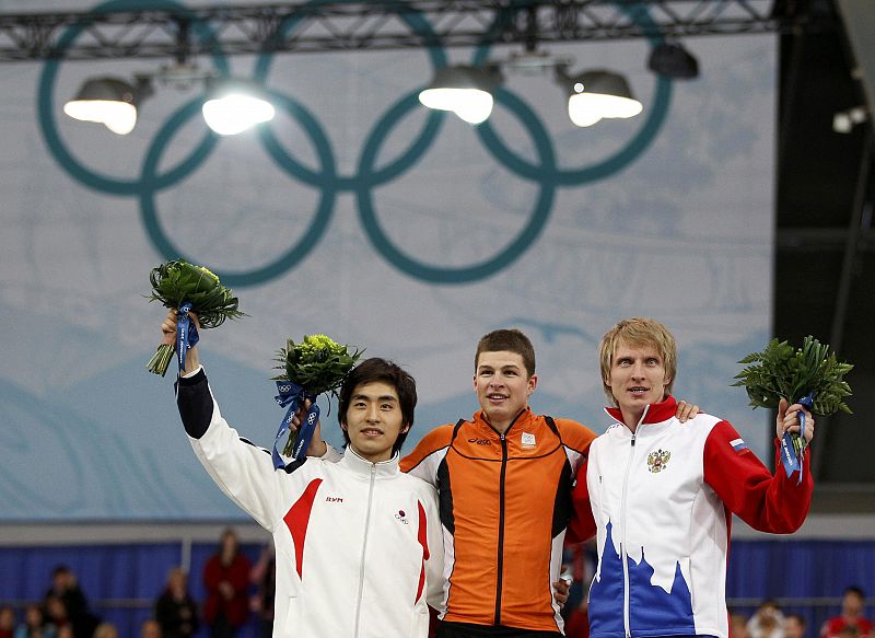 Medallists stand together on the podium after competing in the men's 5000 meters speed skating race at the Richmond Olympic Oval during the Vancouver 2010 Winter Olympics