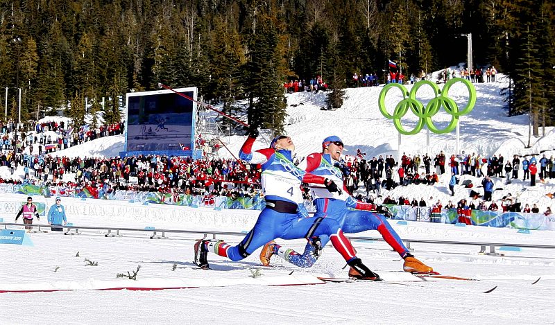Russias Kriukov crosses the finish line next to team mate Panzhinskiy to win men's 1,5 km individual sprint classic cross-country final at the Vancouver 2010 Winter Olympics in Whistler